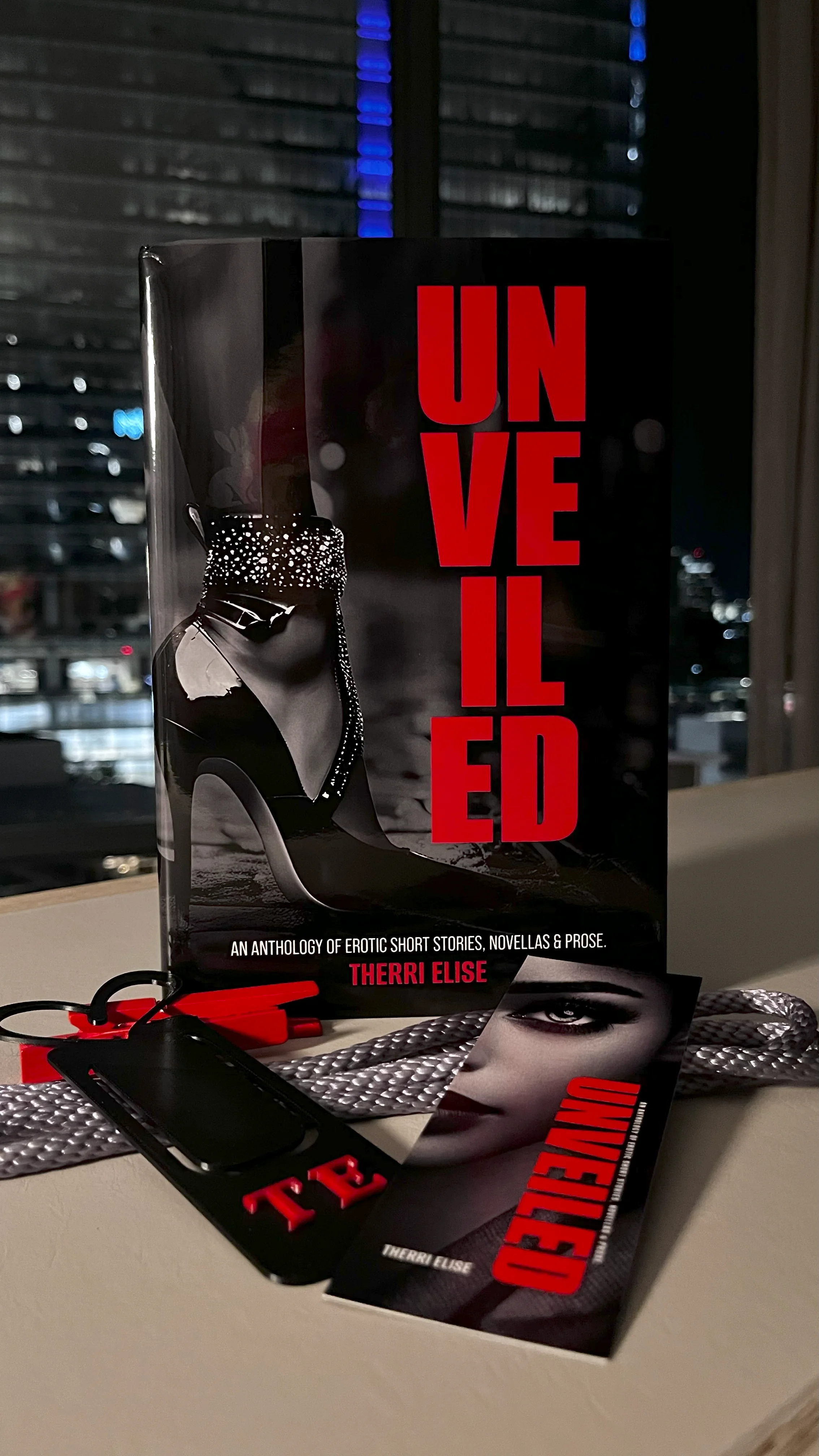 Therri Elise's books and creative workspace featuring UNVEILED